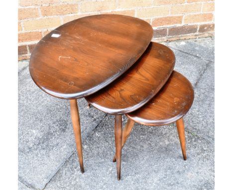 AN ERCOL NEST OF THREE MODEL 354 'PEBBLE' OCCASIONAL TABLES  the largest 64cm x 44cm, 40cm high, the smallest 34cm x 24cm, 34