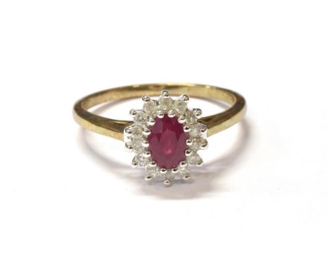 RUBY &amp; DIAMOND CLUSTER RING IN 9CT GOLD  Ballerina style oval cluster, set with an oval ruby est 0.66 carats, surrounded 