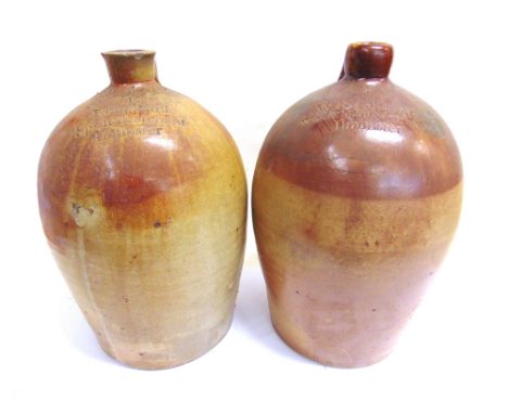 TWO STONEWARE FLAGONS  comprising one impressed '4 / W R Tapscott / Wine &amp; Spirit Merchant / Ilminster', 46cm high (small