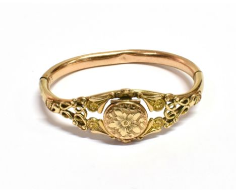 VICTORIAN PINCHBECK LOCKET BANGLE 22.8mm wide front section, decorated with scrolling ribbons and flowers, the centre piece b