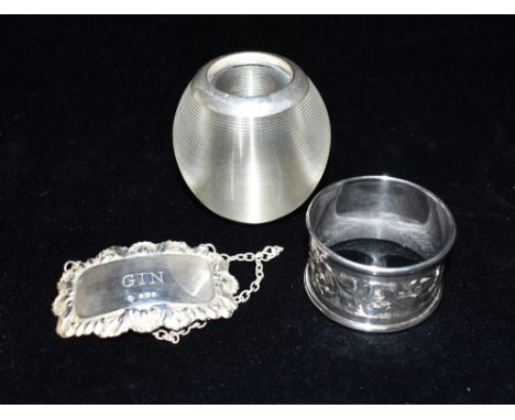 SILVER STRIKER, NAPKIN RING &amp; GIN LABEL A silver rimmed glass match striker, hallmarked London 1905. Weight 191.8 grams. 