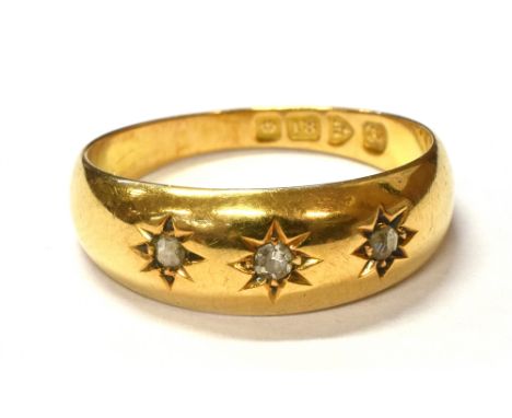 ESTATE CUT DIAMOND GYPSY 18CT GOLD RING Three star burst grain settings, containing an old single and two senaille cut diamon