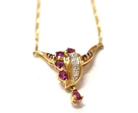 RUBY &amp; DIAMOND 14CT GOLD LAVALIER A claw set ribbon and leaf style setting, with mixed cut rubies, estimated to total 1.5
