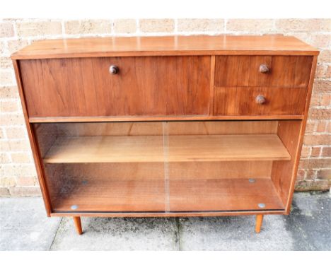 AN AVALON TEAK CABINET  fitted with drop-down cupboard and two drawers above sliding glass doors enclosing adjustable shelf, 