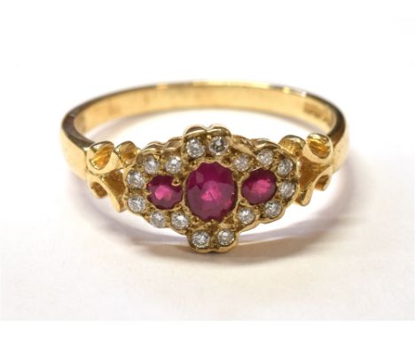 RUBY &amp; DIAMOND TRIPLE CLUSTER RING Three mixed cut rubies, est to total 0.40 carats, surrounded by round brilliant cut di