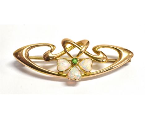 ART NOUVEAU WHITE OPAL &amp; PERIDOT BROOCH 3.6cm long of flowing ribbon design, with a centre piece of three heart shaped ca