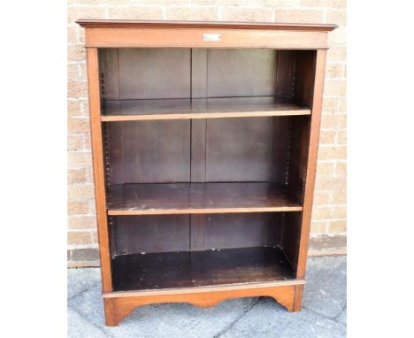 AN EDWARDIAN MAHOGANY BOOKCASE  with crossbanded decoration, fiited with two adjustable shelves, 84cm wide Condition Report :