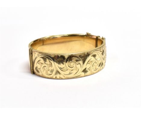 ANTIQUE ROLLED GOLD CUFF BANGLE 21.6mm wide hinged cuff bangle with foliate and scroll engraved decoration to front and plain