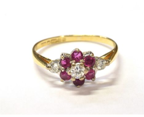 MODERN 18CT RUBY &amp; DIAMOND CLUSTER RINGFloral cluster set with a central approx 0.12 carat diamond surrounded by six roun