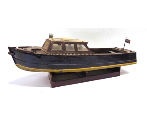 A MODEL OF A POLICE LAUNCH  of principally wood construction, with a plank effect deck, the hull painted black over pale gree