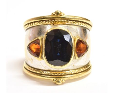 THEO FENNELL SAPPHIRE BOMBE RING Handmade ring in 18ct yellow gold with rhodium plating to centre of band. Central bezel set,