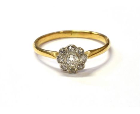 ESTATE CUT DIAMOND FLORAL CLUSTER RING Mille grain set cluster of eight old single cut and one old Swiss cut diamond, on 18ct