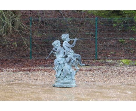 A neoclassical bronzed-metal fountain, of recent manufacture, in the form of three putti playing flutes, 79cm diameter 120cm 