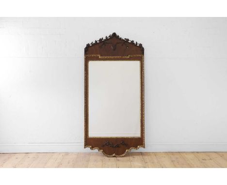 A George II-style mahogany and parcel-gilt pier mirror,  19th century, the arched pediment with carved floral and foliate orn