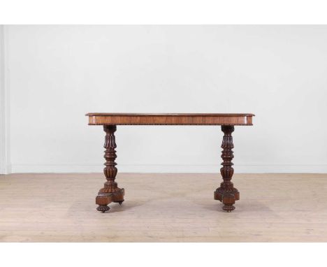 A George IV rosewood centre table in the manner of Gillows, c.1825, with a rounded rectangular top with a beaded lower edge, 