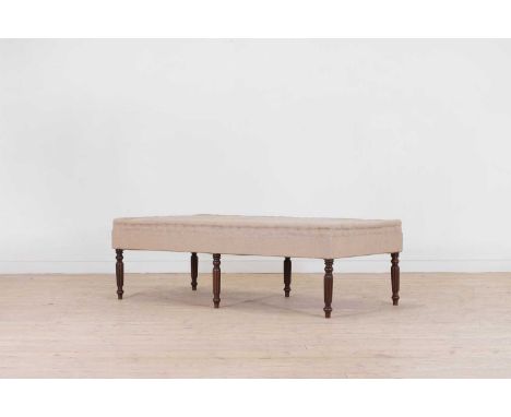 A large George IV-style mahogany footstool, of recent manufacture but incorporating earlier elements, the rectangular seat wi