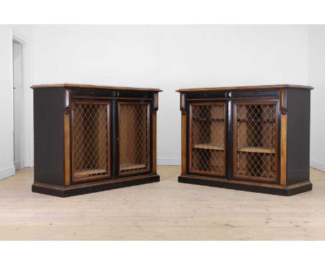 A pair of fruitwood and ebonised library bookcases, first half of the 19th century, French, each with a white marble top, abo