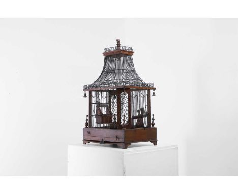 A George III chinoiserie birdcage, the wirework cage of pagoda form, with canted corners and turned mahogany finials and pend