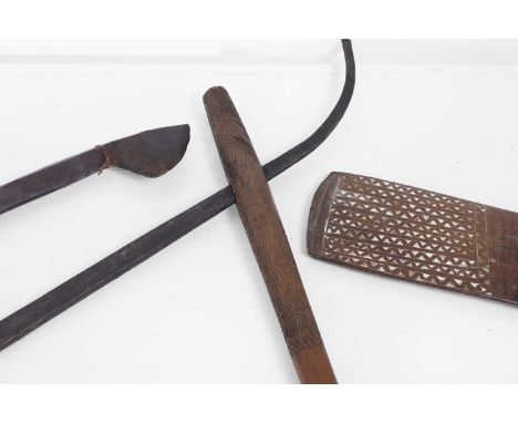 A carved redwood club, 20th century, Papua New Guinea, with a paddle head decorated with zigzags, 70.5cm long, a hardwood axe
