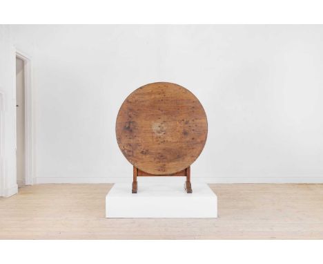 A provincial sycamore tavern table, 19th century, the circular fruitwood top raised on moulded supports united by stretchers,