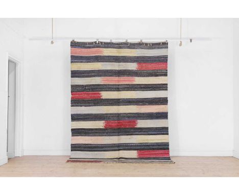 A cotton rag rug, early 20th century, Northern European, stitched with individual strands of varying fabrics in a polychrome 
