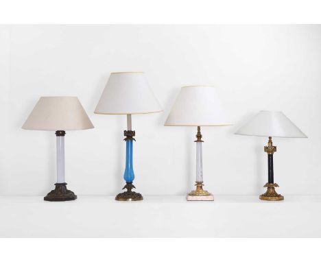 An assembled set of four table lamps, late 19th/early 20th century, comprising a Palmer &amp; Co. Patent opaline glass exampl