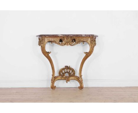 A Louis XV giltwood pier table, mid-18th century, French, of serpentine outline with a rouge marble top, raised on scrolling 