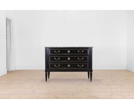A Louis XVI ebonised wooden commode, late 18th century and later, French, the grey marble top above three long drawers, raise