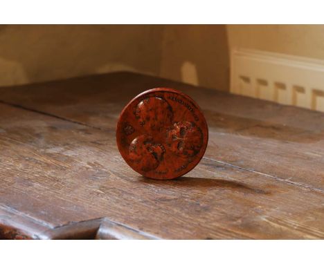 A burr wood circular apothecary patch box, 19th century, relief-decorated and inscribed 'Cranologie du Docteur Calu', with a 