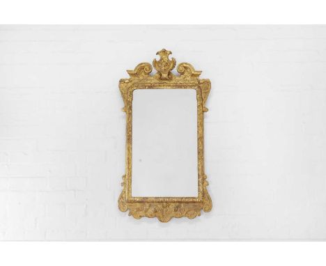 A George I-style carved giltwood and gesso mirror, probably late 19th/early 20th century, incorporating some earlier elements