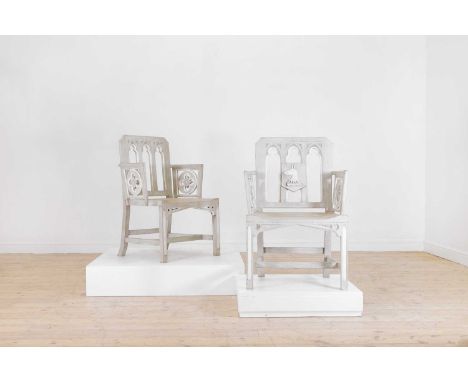 A pair of George III-style painted oak hall chairs, 20th century, each with a pierced tracery back and quatrefoil detail to t
