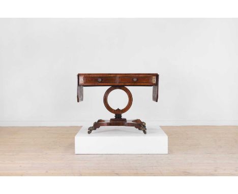A Regency rosewood, satinwood, and brass sofa table, c.1820, with a canted rectangular top with drop ends, a pair of frieze d