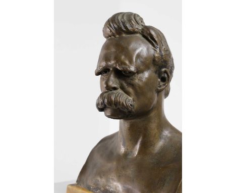 After Max Klinger, a portrait bust of Friedrich Wilhelm Nietzsche (1844-1900), patinated bronze on a marble plinth, stamped t