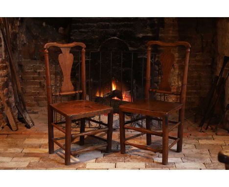 A pair of George II provincial ash and elm side chairs, mid-18th century, each with a vase-shaped splat, panel seat, and on s