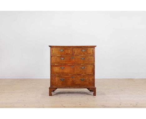 A walnut and feather-banded chest of drawers, 18th century and later, the rectangular top with matched veneers, above two sho
