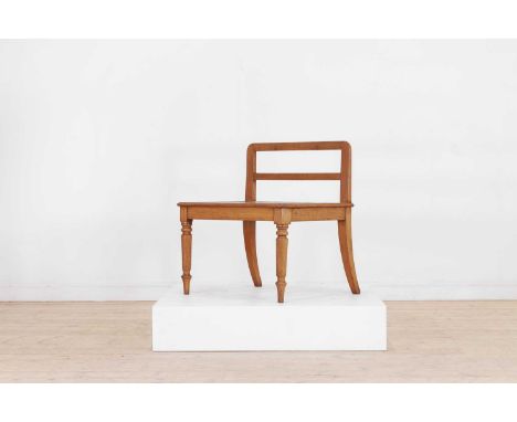 A large Victorian mahogany luggage rack, c.1890, with a high back and moulded rectangular top with chamfered slats, raised on