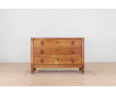 A neoclassical fruitwood commode, late 18th/early 19th century, Continental, the rectangular marble top above three long draw