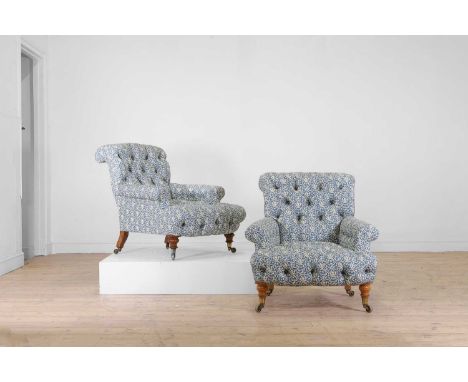 A matched pair of early Victorian club armchairs by Howard & Sons, c.1850, each button-upholstered in blue and white H&amp;S 