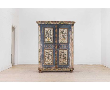 A painted pine marriage cupboard, 19th century, Austrian, with a moulded cornice, above a pair of panelled doors decorated wi
