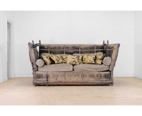 A velvet-upholstered Knole sofa, early 20th century, with silk trim, raised on brass castors, distressed, 237cm wide 101cm de