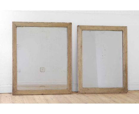 A near pair of painted wooden pier mirrors, early 19th century, each rectangular frame with red decoration surrounding a merc