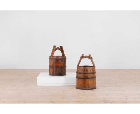 A pair of coopered elm buckets, late 19th/early 20th century, Chinese, each of cylindrical form with tapered handles,34cm dia