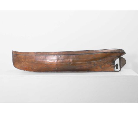 A copper ship's hull model,  early 20th century, with an articulated propeller and rudder,  118cm long 27cm wide 21cm high  P