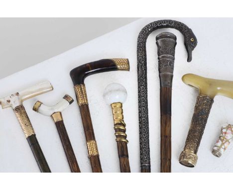 A collection of Edwardian parasol and cane handles and mounts, early 20th century, including six partridgewood examples, two 