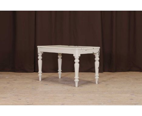 A painted wooden luggage stand, 20th century, with a rounded rectangular top, above tapering turned supports terminating in p