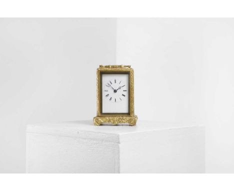 A brass carriage clock by Jules of Paris, late 19th century, French, the ornately cast case enclosing an enamel face inscribe