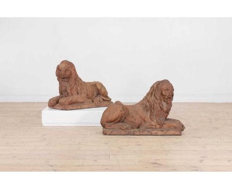A pair of terracotta recumbent lions, 18th century, Italian, each resting on a rectangular plinth, with damages,75cm long30cm