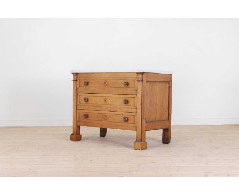 A neoclassical fruitwood commode, late 18th/early 19th century, northern European, with a shaped white marble top, above thre