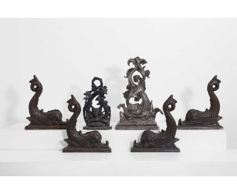 A collection of six bronze doorstops, late 19th/early 20th century, comprising:a silvered-metal example of a stylised dolphin