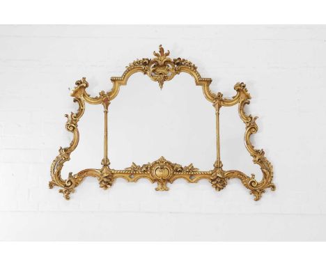 A George III-style giltwood overmantel mirror, early 20th century, in the Chippendale taste, the frame of scrolling rococo ou